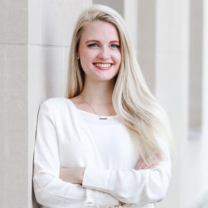 Headshot of female Digital Maelstrom member smiling with arms crossed